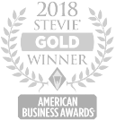 Leaves forming a circle with the words 2018 Stevie Gold Winner and a gray banner underneath with the words American Business Awards in white